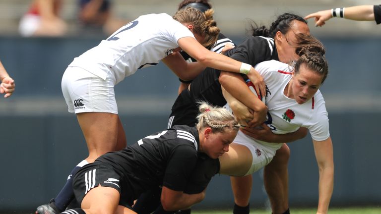 Emily Scarratt is wrapped up by the Black Ferns defence