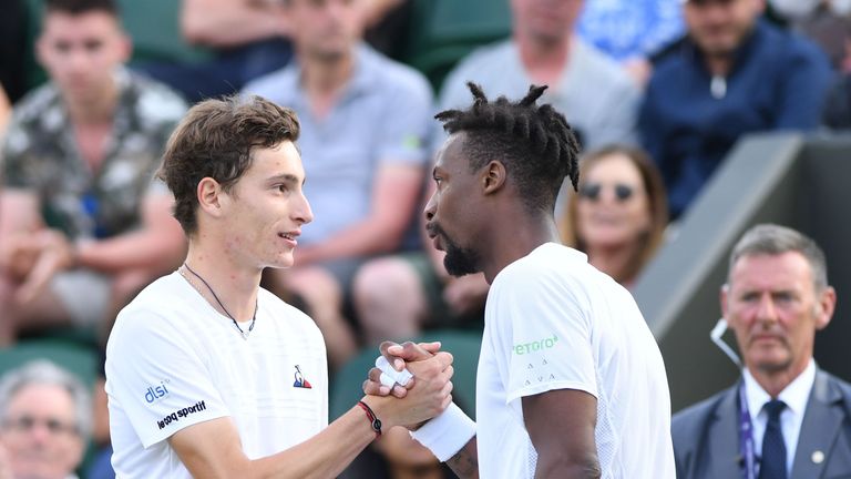 Gael Monfils (right) received treatment to his ankle before retiring in the decider