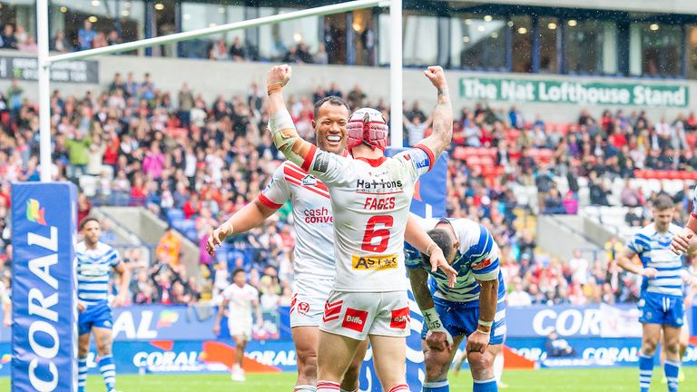 St Helens' Joseph Paulo congratulates Theo Fages on scoring a try against Halifax