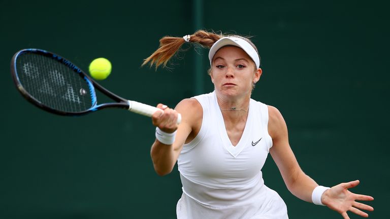 Katie Swan of Great Britain plays a forehand in her Ladies' Singles first round match against Laura Siegemund of Germany during Day two of The Championships - Wimbledon 2019 at All England Lawn Tennis and Croquet Club on July 02, 2019 in London, England