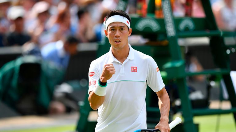 Kei Nishikori celebrates winning the first set against Switzerland's Roger Federer during their men's singles quarter-final match on day nine of the 2019 Wimbledon Championships at The All England Lawn Tennis Club in Wimbledon, southwest London, on July 10, 2019