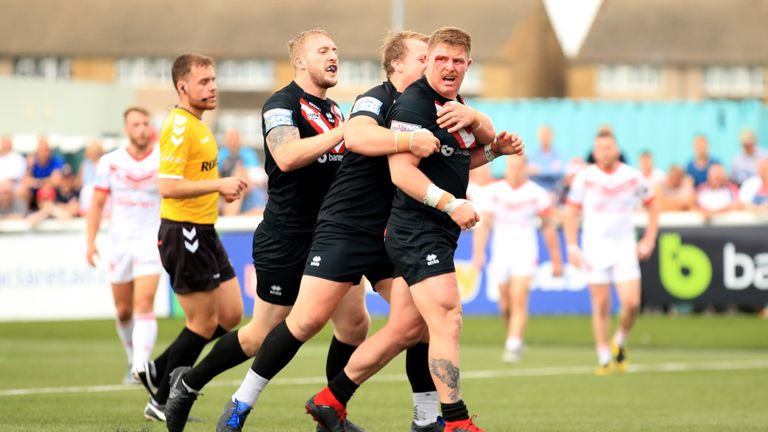 London Broncos' Luke Yates celebrates wtih his team-mates after he scores against St Helens