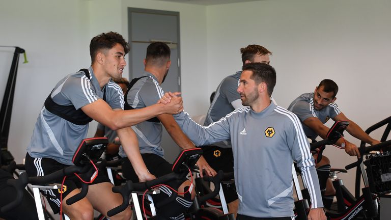 Max Kilman and Joao Moutinho greet each other at the Wolves training ground
