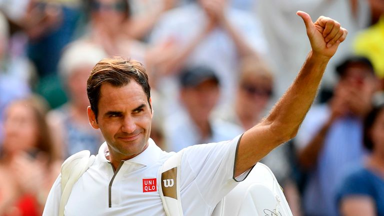 Roger Federer waves as he leaves the court after beating Japan's Kei Nishikori during their men's singles quarter-final match on day nine of the 2019 Wimbledon Championships at The All England Lawn Tennis Club in Wimbledon, southwest London, on July 10, 2019