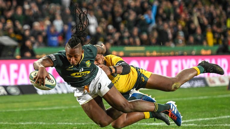 South Africa's S'busiso Nkosi (L) scores his try despite the opposition of Australia's Samu Kerevi during the 2019 Rugby Championship match South Africa v Australia, at the Emirates Airline Park in Johannesburg, on July 20, 2019. (Photo by Christiaan Kotze / AFP) (Photo credit should read CHRISTIAAN KOTZE/AFP/Getty Images)