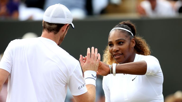 Serena Williams of the United States (R) high fives Andy Murray of Great Britain in their Mixed Doubles third round match against Bruno Soares of Brazil and Nicole Melichar of the United States during Day Nine of The Championships - Wimbledon 2019 at All England Lawn Tennis and Croquet Club on July 10, 2019 in London, England.