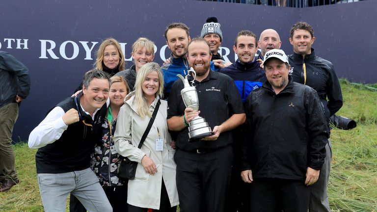 Shane Lowry celebrates with members of his family and his management team