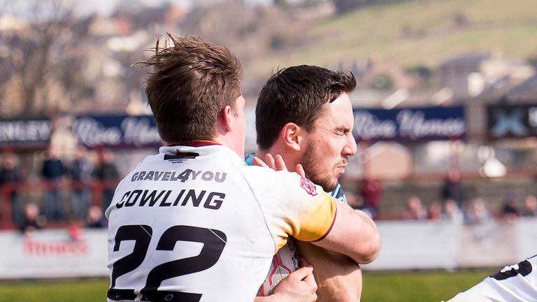 Picture by Allan McKenzie/SWpix.com - 25/03/2018 - Rugby League - Betfred Championship - Batley Bulldogs v Featherstone Rovers - Heritage Road, Batley, England - Featherstone's Tom Holmes is tackled by Batley's Danny Cowling.