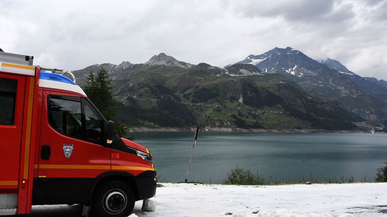 An emergency vehicle is parked on the snowcovered roadside following a massive hail storm obliging the organization to abandon the race during the nineteenth stage of the 106th edition of the Tour de France cycling race between Saint-Jean-de-Maurienne and Tignes, in Tignes, on July 26, 2019. (Photo by JEFF PACHOUD / AFP) (Photo credit should read JEFF PACHOUD/AFP/Getty Images)