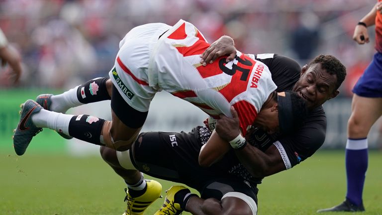 William Tupou of Japan is tackled by Leone Nakarawa