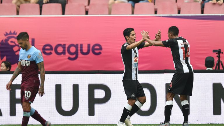Newcastle United&#39;s Yoshinori Muto (C) celebrates his goal against West Ham during their match for the third place at the 2019 Premier League Asia Trophy football tournament at the Hongkou Stadium in Shanghai, on July 20, 2019. (Photo by HECTOR RETAMAL / AFP) (Photo credit should read HECTOR RETAMAL/AFP/Getty Images)