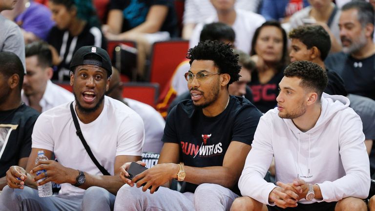 LaVine (right) takes in a Summer League game with Bulls team-mates Thaddeus Young and Otto Porter Jr