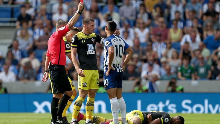 Florin Andone is shown a red card by referee Kevin Friend