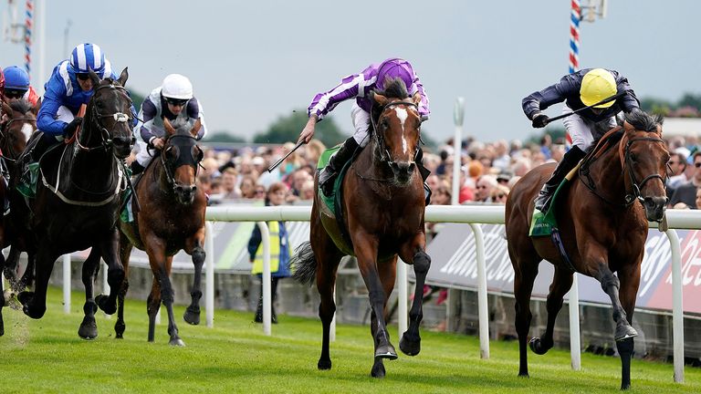 Ryan Moore riding Japan (purple and white) win the Juddmonte International Stakes from Crystal Ocean