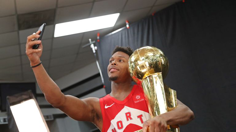 Toronto Raptors point guard Kyle Lowry celebrates with the Larry O'Brien trophy