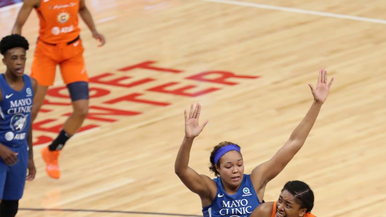 Morgan Tuck is bottled up by the Minnesota Lynx defense