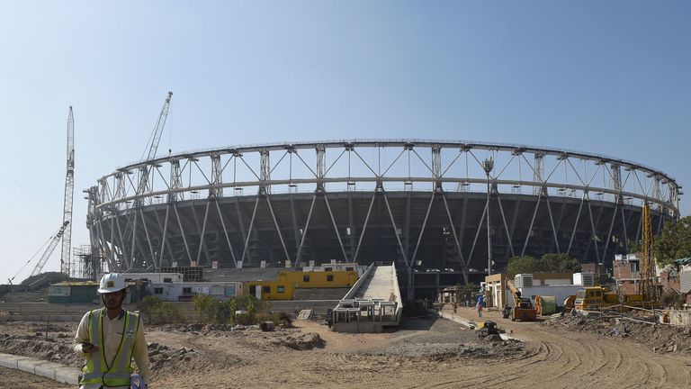 In this picture taken on January 25, 2019, An Indian official walks past a construction site of the worlds largest cricket stadium at Motera, some 11 km from Ahmedabad. - The cricket stadium will have a seating capacity of 1,10,000 people. Gujarat Cricket Association is planning to inaugurate Motera Stadium during the second quarter of 2019. (Photo by SAM PANTHAKY / AFP) (Photo credit should read SAM PANTHAKY/AFP/Getty Images)