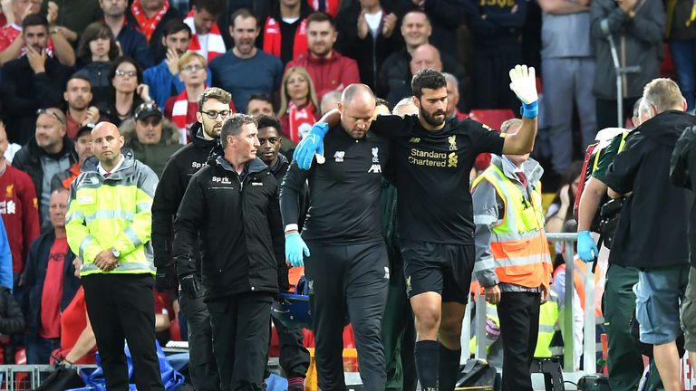 Alisson leaves the pitch following an injury