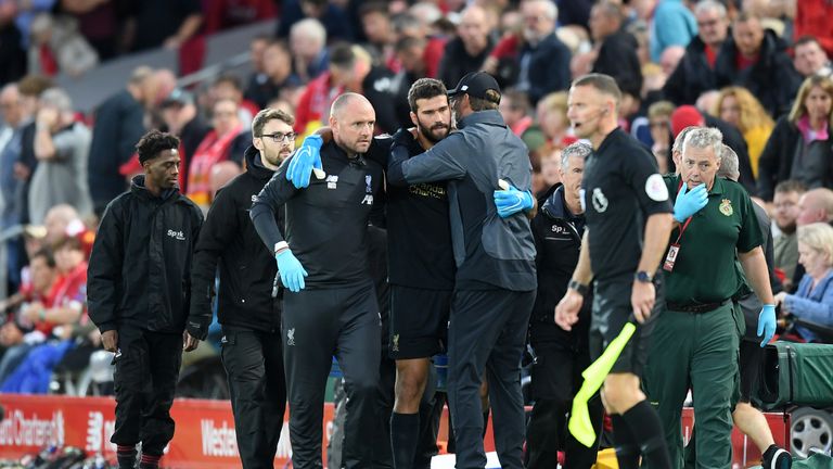 Alisson hobbles off during Liverpool v Norwich at Anfield