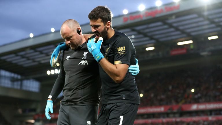 Alisson leaves the pitch after picking up an injury