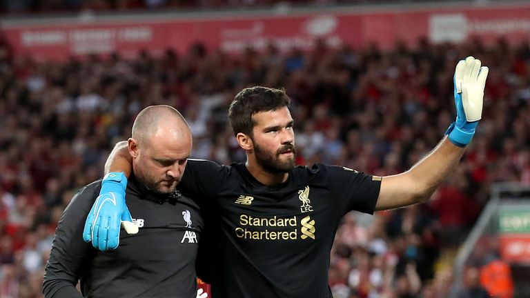 Alisson leaves the pitch after picking up an injury