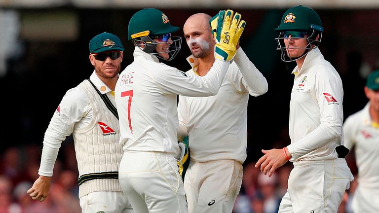 Australia's Nathan Lyon (C) and Australia's captain Tim Paine (2L) celebrate the wicket of England's Stuart Broad for 11 runs on the second day of the second Ashes cricket Test match between England and Australia at Lord's Cricket Ground in London on August 15, 2019. 