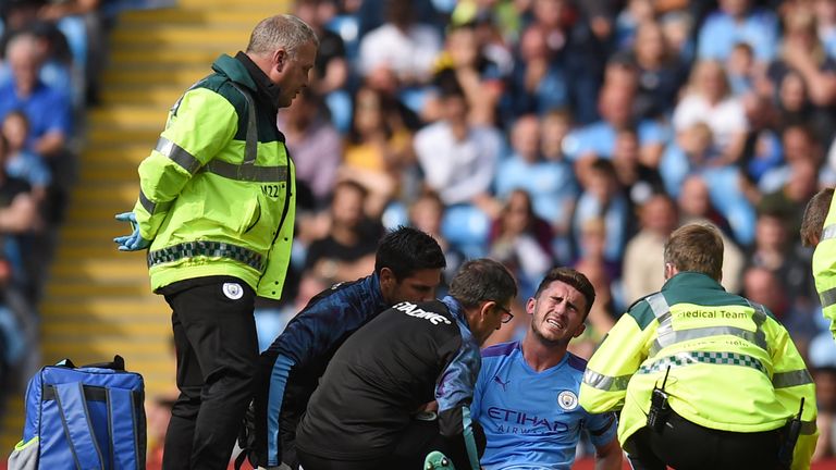 Aymeric Laporte receives medical attention following a challenge with Brighton's Adam Webster