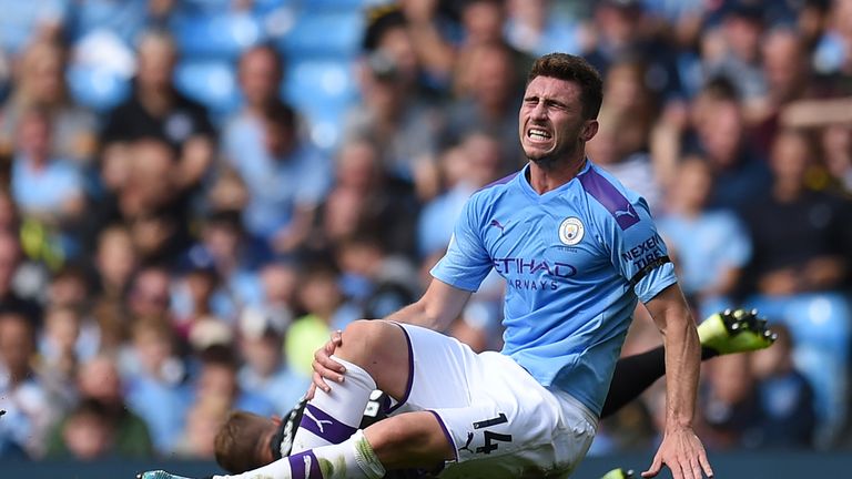 Aymeric Laporte picks up an injury following a challenge with Brighton's Adam Webster