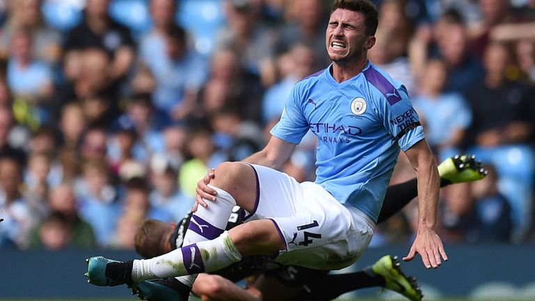 Laporte clutches his knee after a challenge with Brighton's Adam Webster