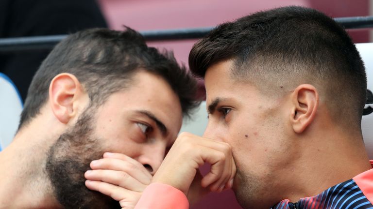 Bernardo Silva and Joao Cancelo talk on the bench during Manchester City's win over West Ham in August 2019