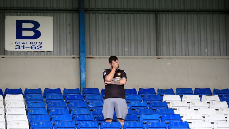 A disconsolate Bury fan in the stands at Gigg Lane