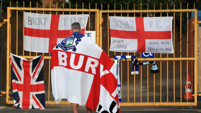 A disconsolate Bury fan awaits news of Bury's fate outside the gates of Gigg Lane