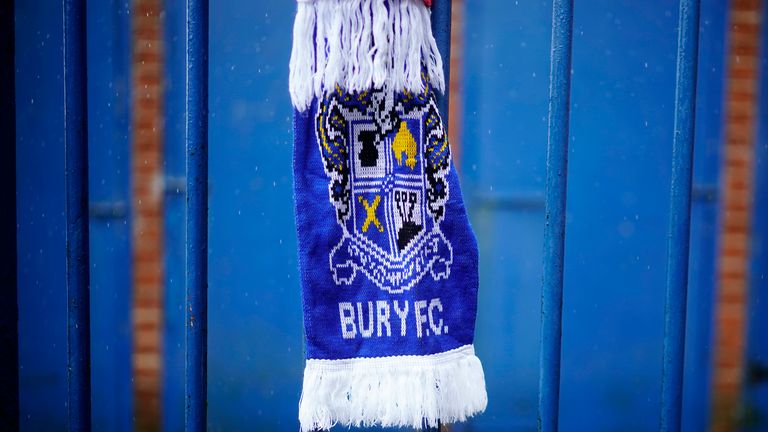 A scarf is tied to the fence of Gigg Lane, home of struggling League One club Bury FC