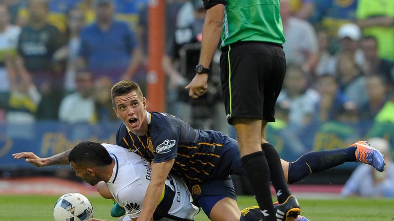 Boca Juniors' Carlos Tevez and Rosario Central's Giovani Lo Celso tussle for the ball in 2016