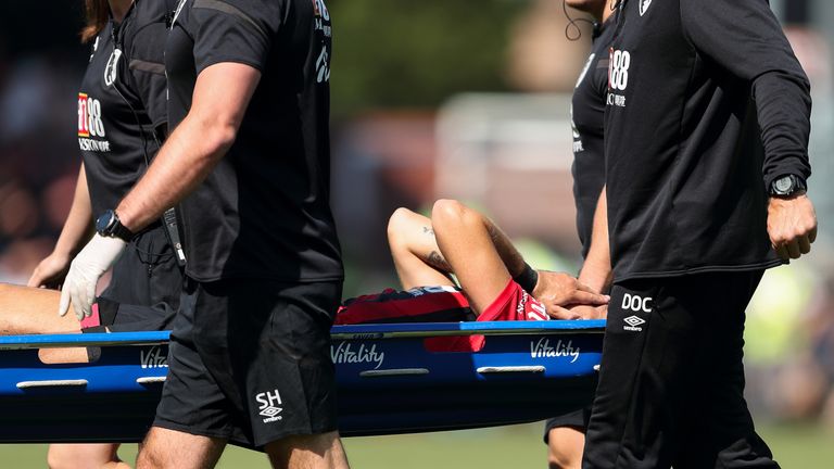 Charlie Daniels is stretchered off against Manchester City