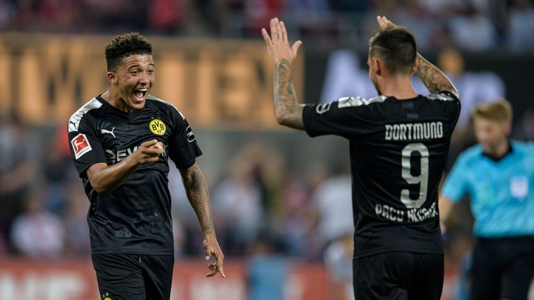 Sancho celebrates his goal with Paco Alcacer in the win over Cologne