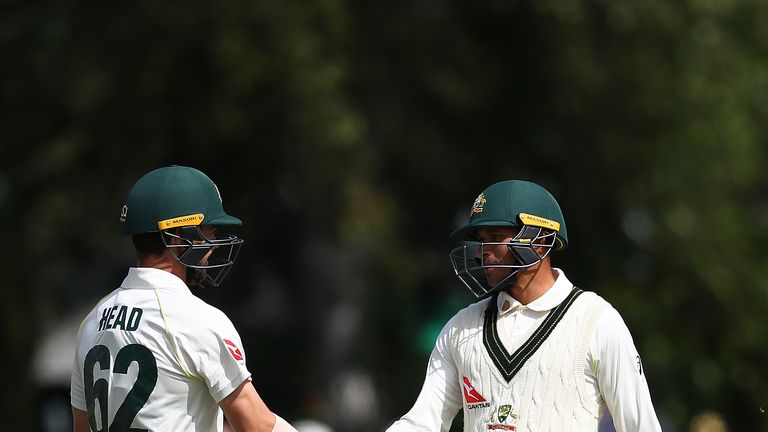 Travis Head congratulates team-mate Usman Khawaja (right) on his half-century at Worcester