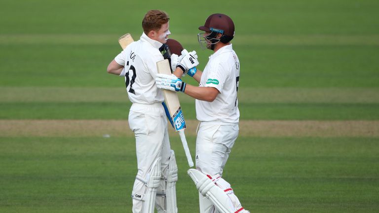 Aaron Finch (R) congratulates Surrey team-mate Ollie Pope on his century against Hampshire at the Oval