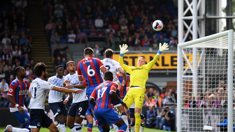 Scott Dann rises to see his header deflect over the bar during a cagey opening period