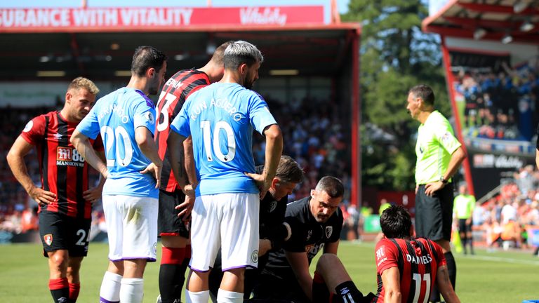 Charlie Daniels is treated on the pitch after dislocating his kneecap in Bournemouth's defeat to Manchester City.