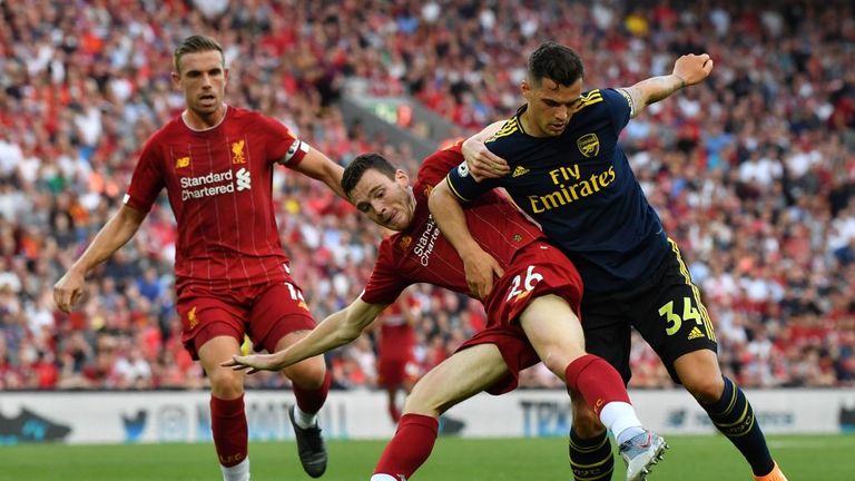 Granit Xhaka battles with Andrew Robertson