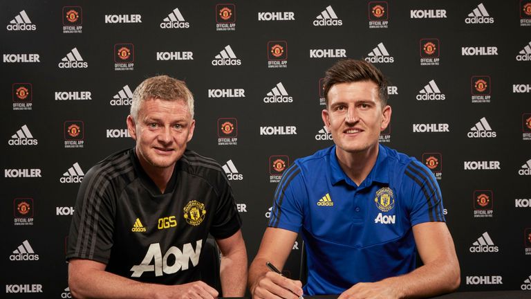 Harry Maguire poses with Ole Gunnar Solskjaer after signing for Manchester United