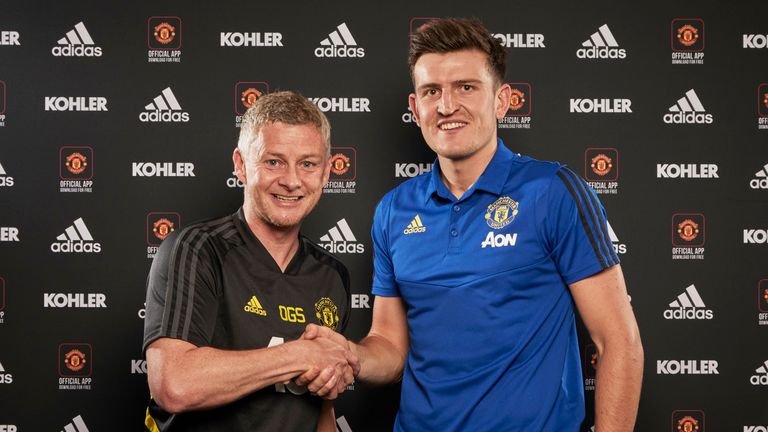Harry Maguire poses with Ole Gunnar Solskjaer after signing for Manchester United