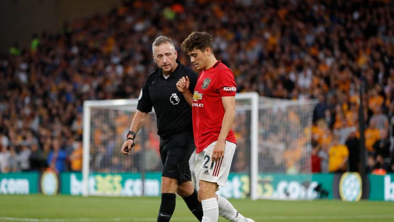 Daniel James with referee Jon Moss during United's draw at Wolves