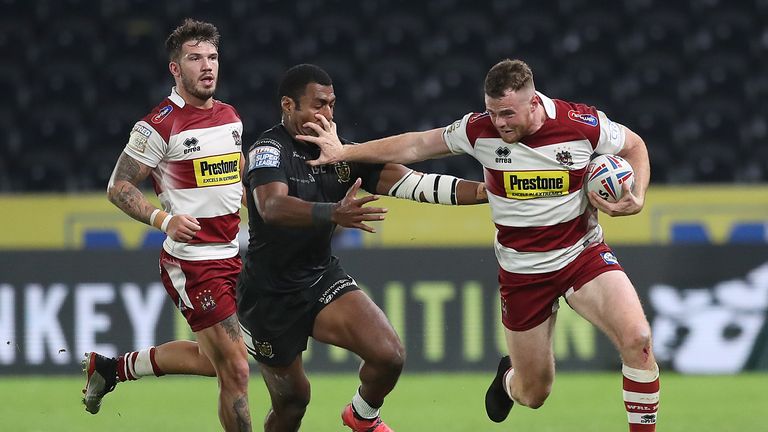 Joe Burgess holds off Hull FC's Ratu Naulago