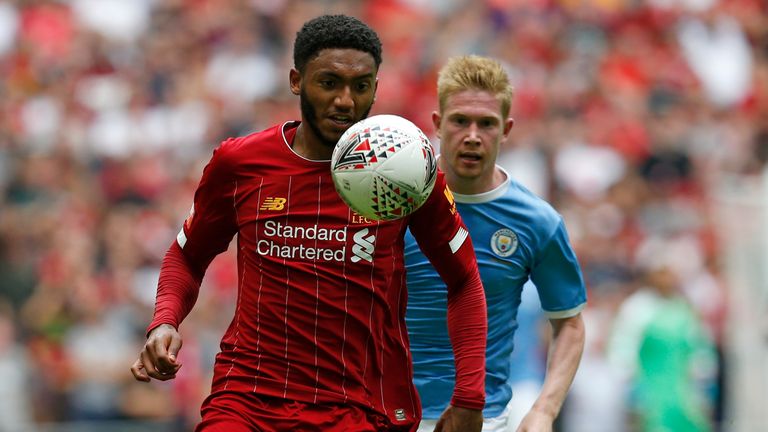 Liverpool defender Joe Gomez shields the ball from Manchester City's Kevin De Bruyne