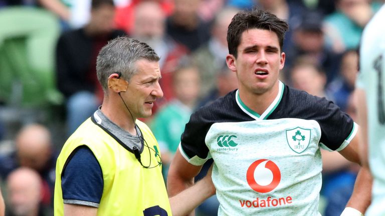 Ireland's fly-half Joey Carbery (R) receives medical attention during the 2019 Rugby World Cup warm-up rugby union match between Ireland and Italy at the Aviva Stadium in Dublin, on August 10, 2019. 