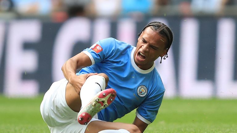 Leroy Sane clutches his leg after picking up an injury during the Community Shield