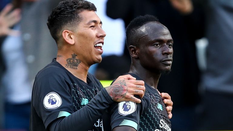 Roberto Firmino celebrates with Sadio Mane after he doubles Liverpool's lead at Turf Moor