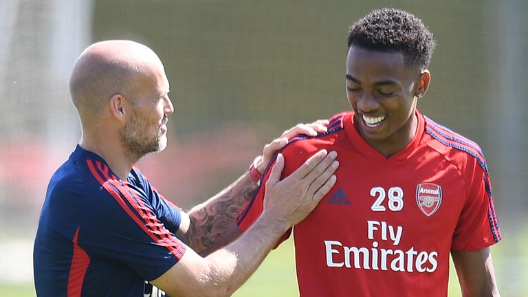 Arsenal coach Freddie Ljungberg has a chat with Joe Willock on the training pitch.